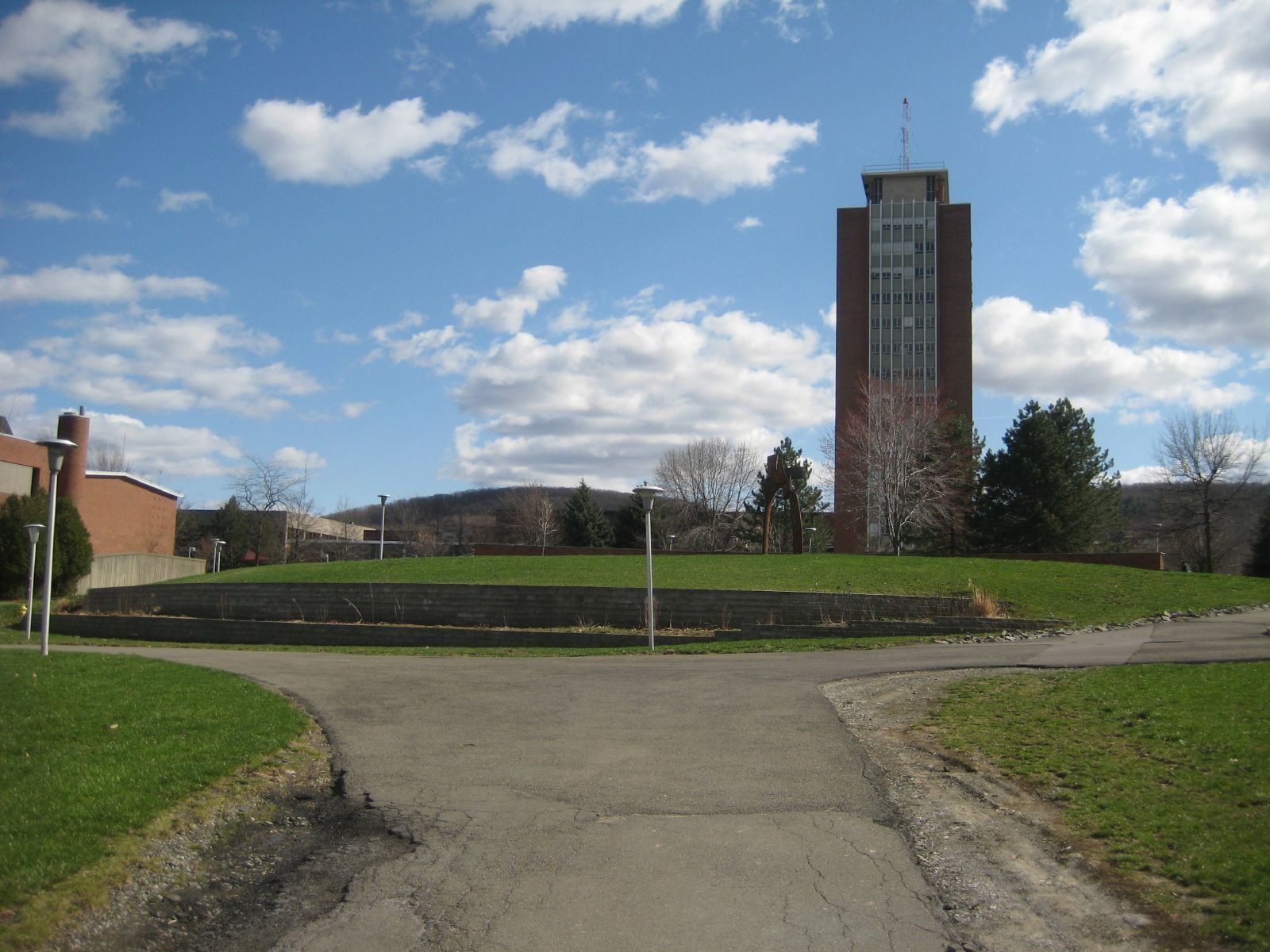 The Binghamton University campus quad with the library tower under a cloudy sky, a Wikimedia Commons photograph in the encyclopedia of Candace Cooley