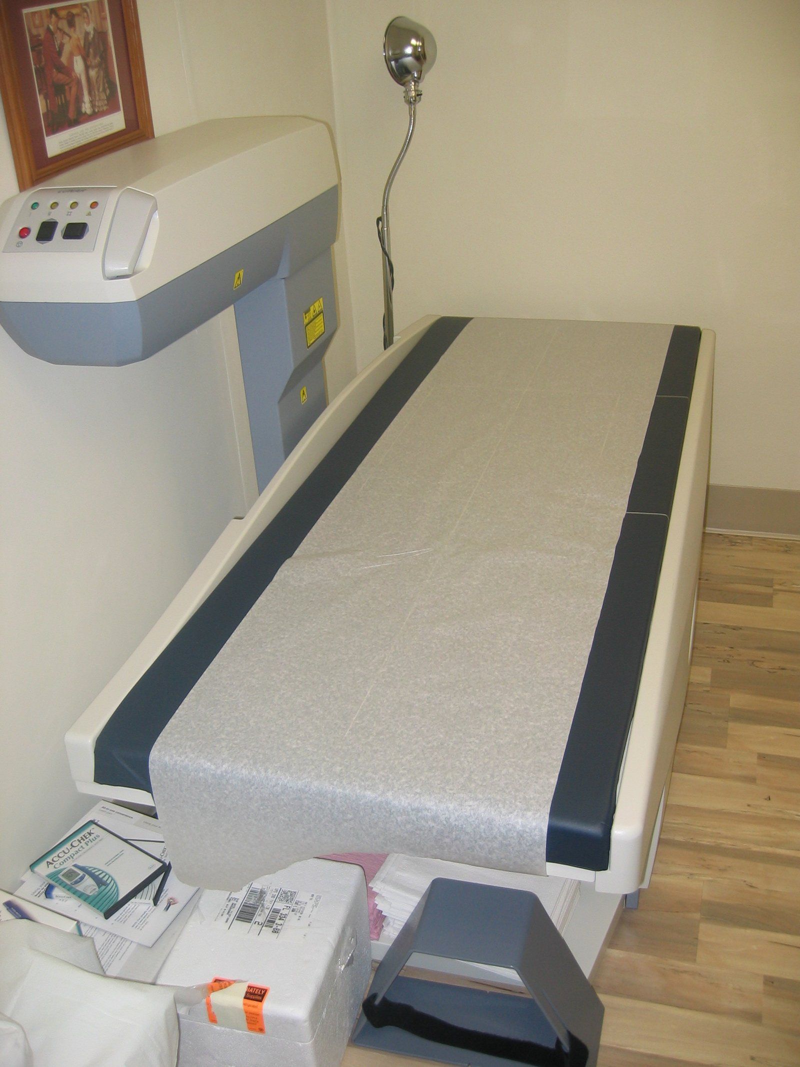 An empty bone densitometry scanner table in an exam room, a Wikimedia Commons photograph in the encyclopedia of Candace Cooley
