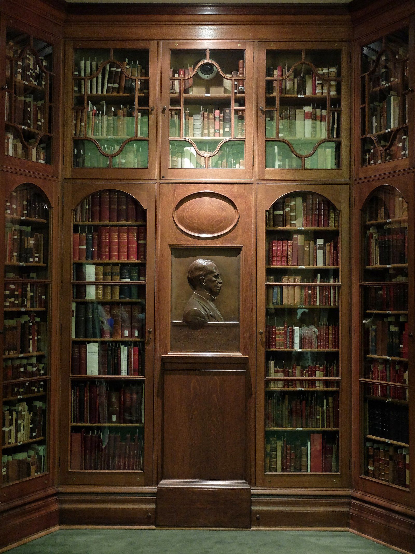 Glass fronted wooden bookcases and a bronze relief in the Osler Library of the History of, a Wikimedia Commons photograph in the encyclopedia of Candace Cooley