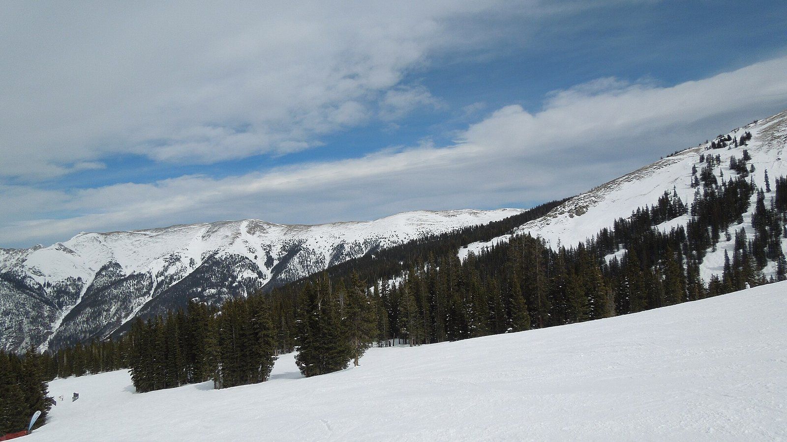 A groomed ski slope at Copper Mountain with the Tenmile Range behind, a Wikimedia Commons photograph in the encyclopedia of Candace Cooley